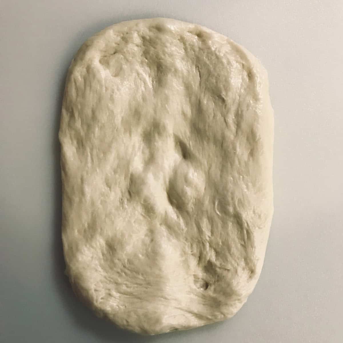 Dough flattened and stretched