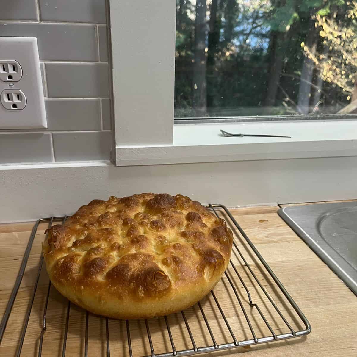 Fully baked focaccia on cooling rack.