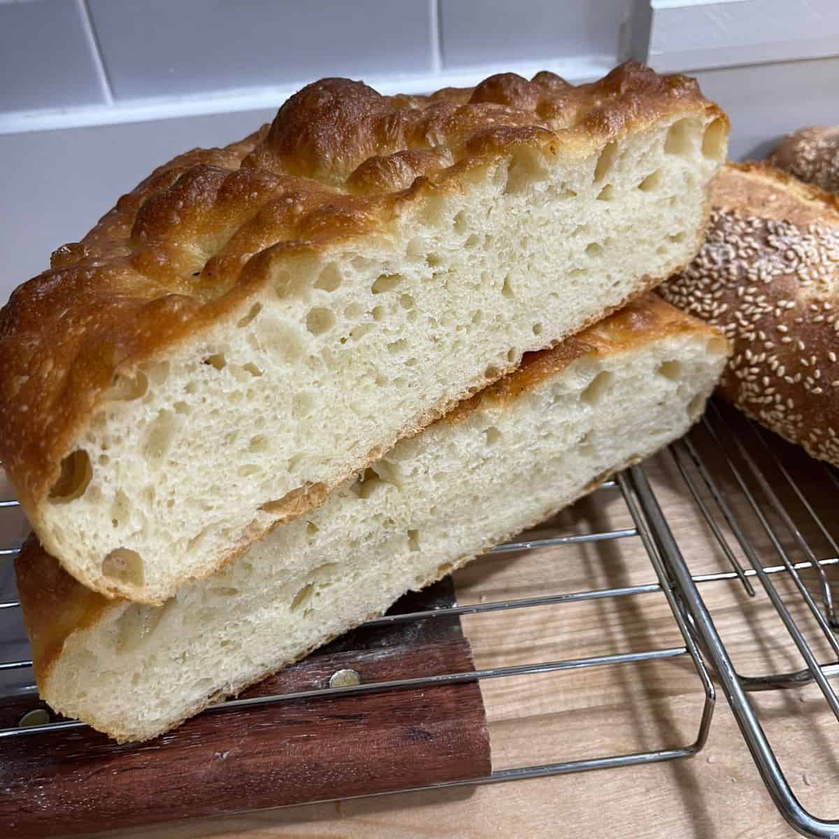 Fluffy focaccia, cut in half, and stacked on top of eachother.