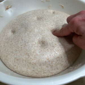 Finger pressed in dough to show indentation.