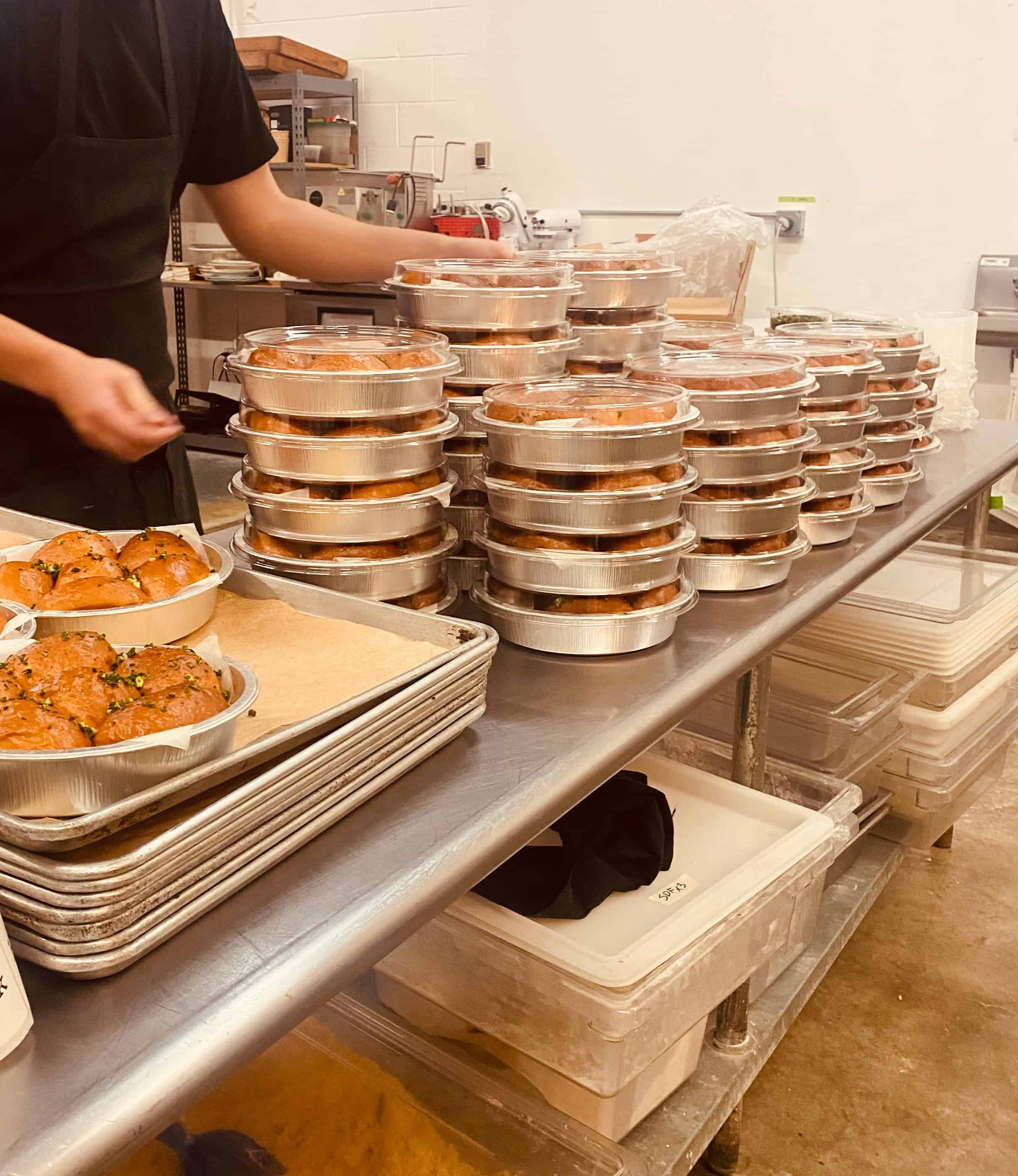 trays of dinner rolls being packaged.
