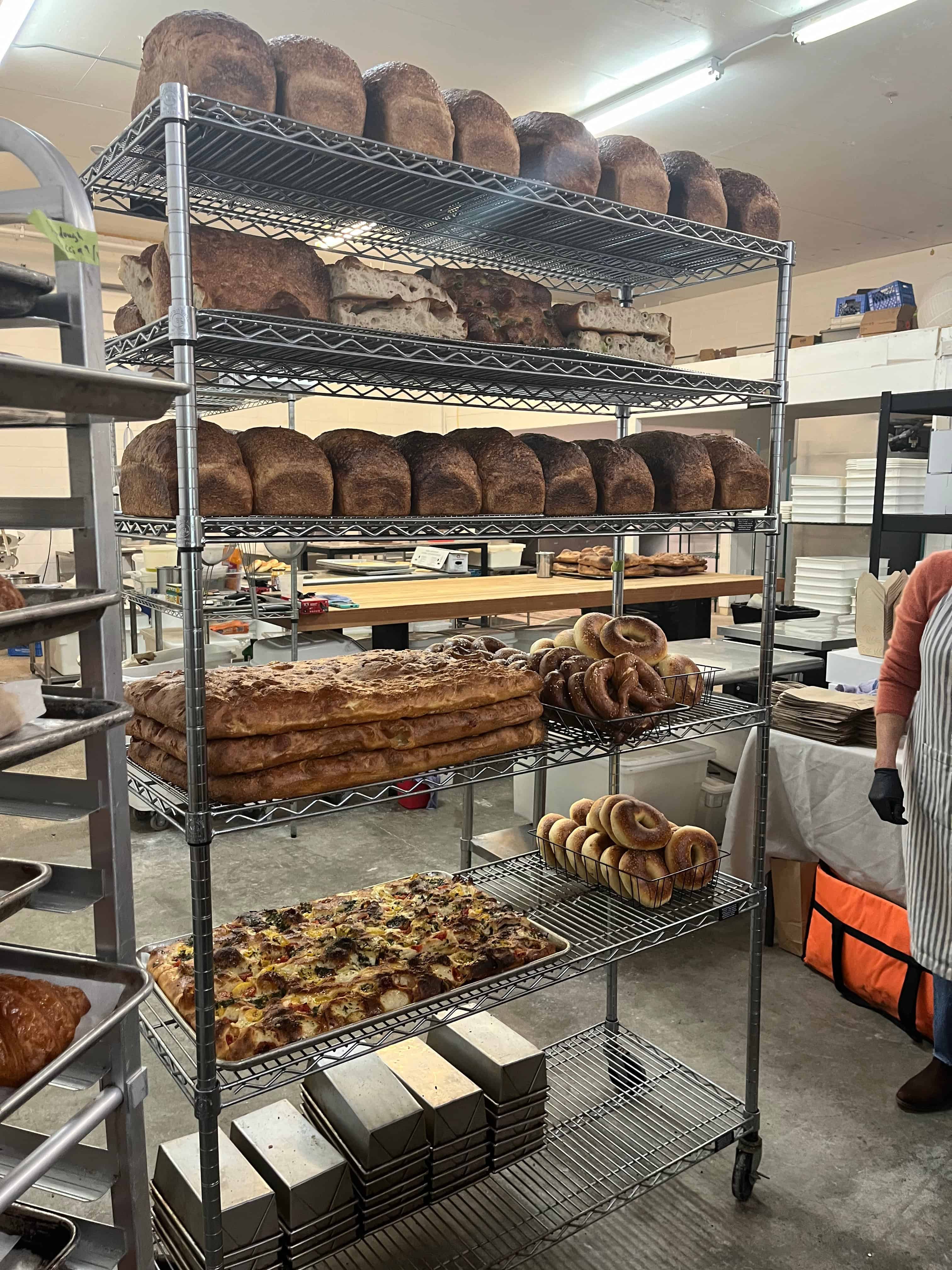 Bread and bagels on a rack.  All produced by using weight measurements.