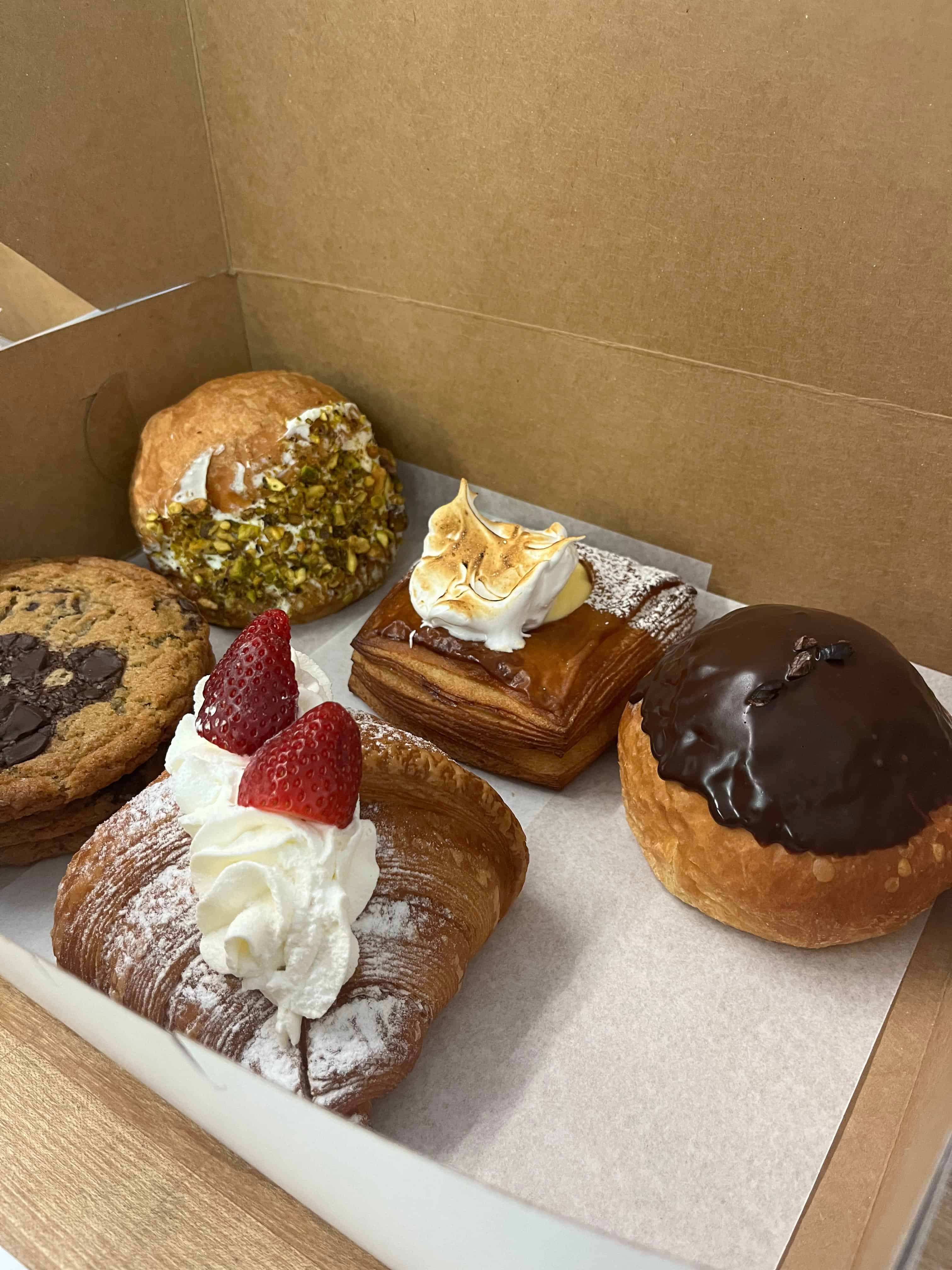 Pastries in a box.  Packaging, presentation, aroma, consistency, service, and reliability all shape perceived value.