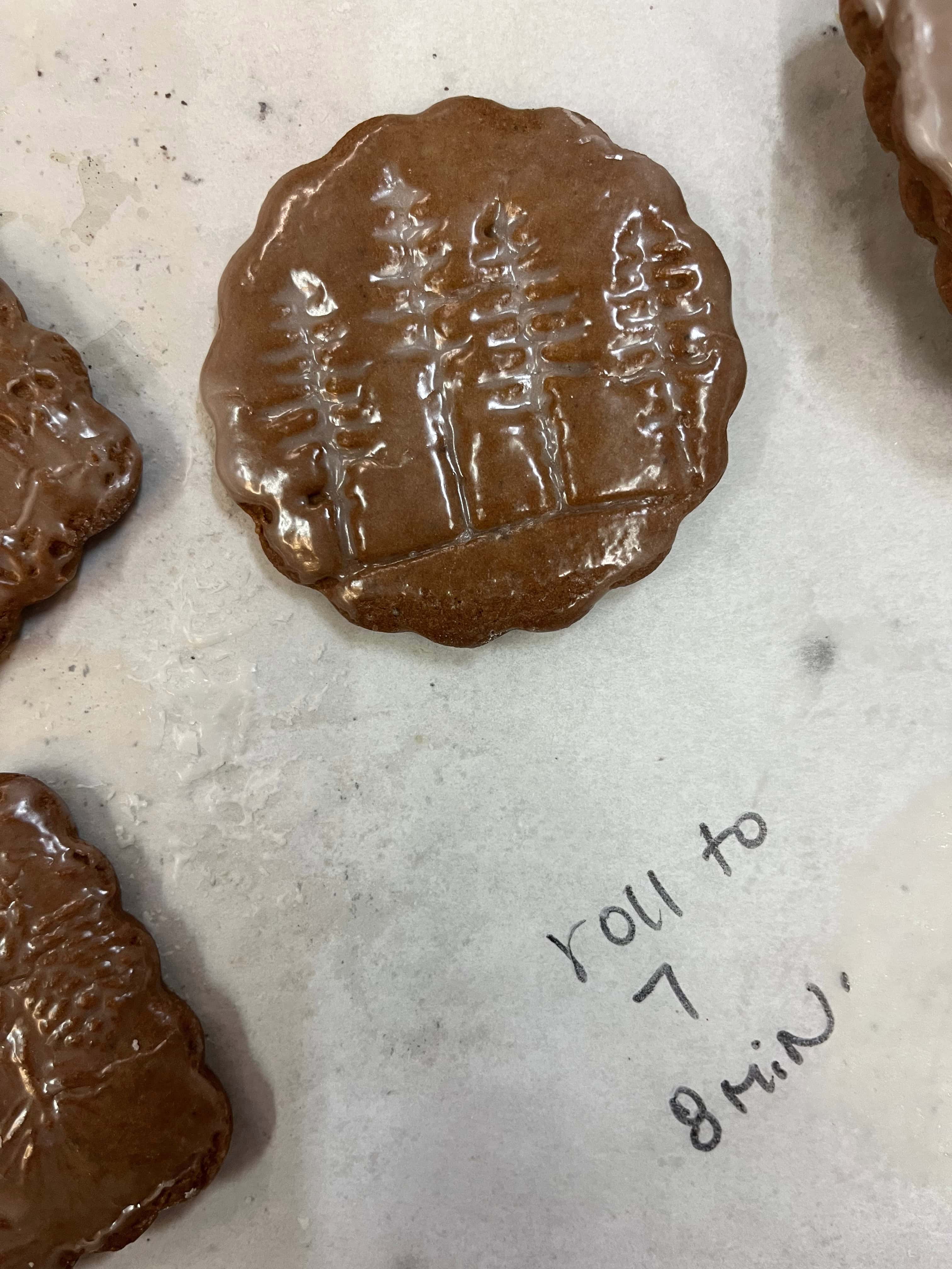 cookies on a parchment with a note to "roll to 7" and bake for "8 minutes"