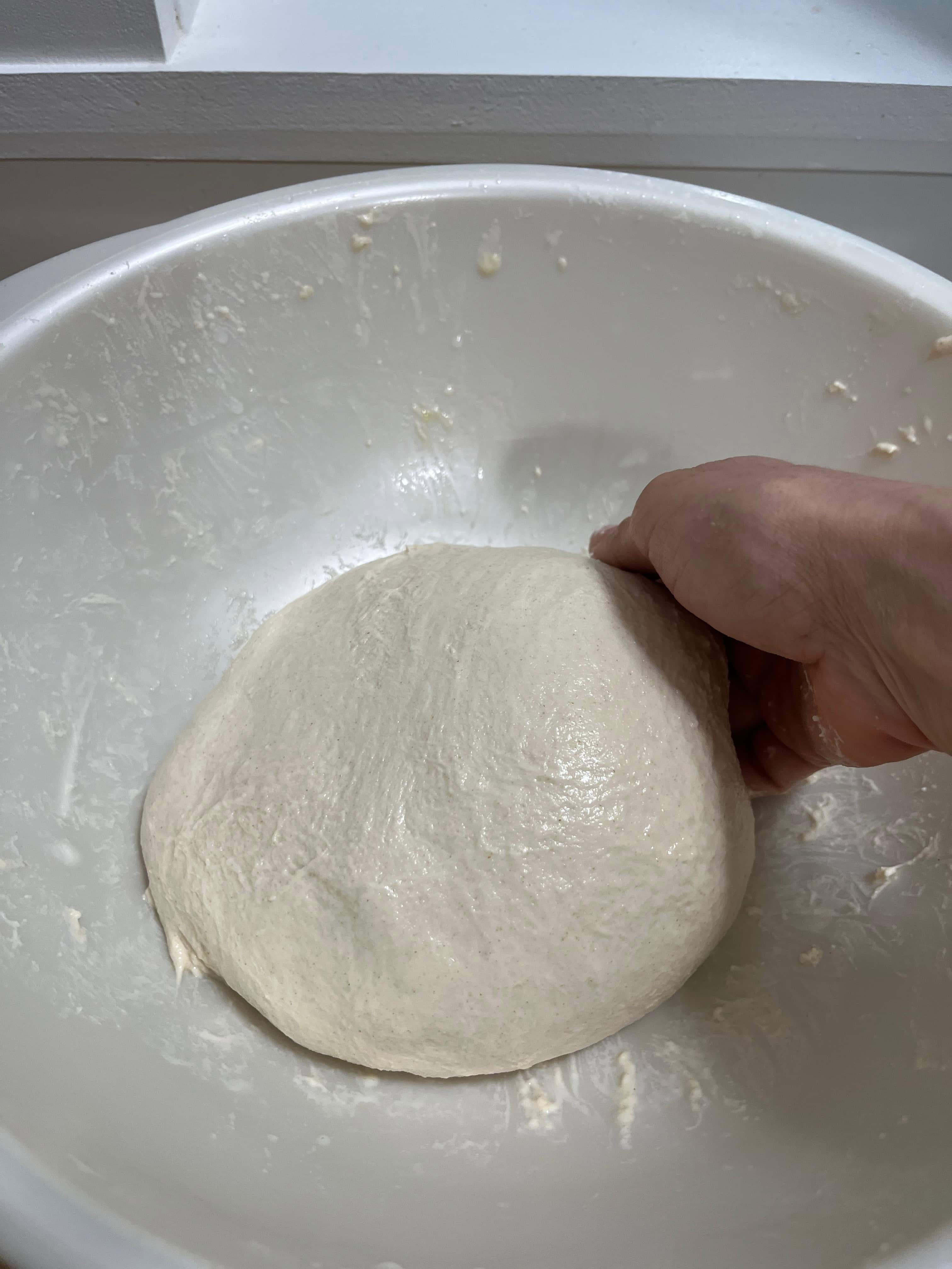 shaping dough into a smooth ball