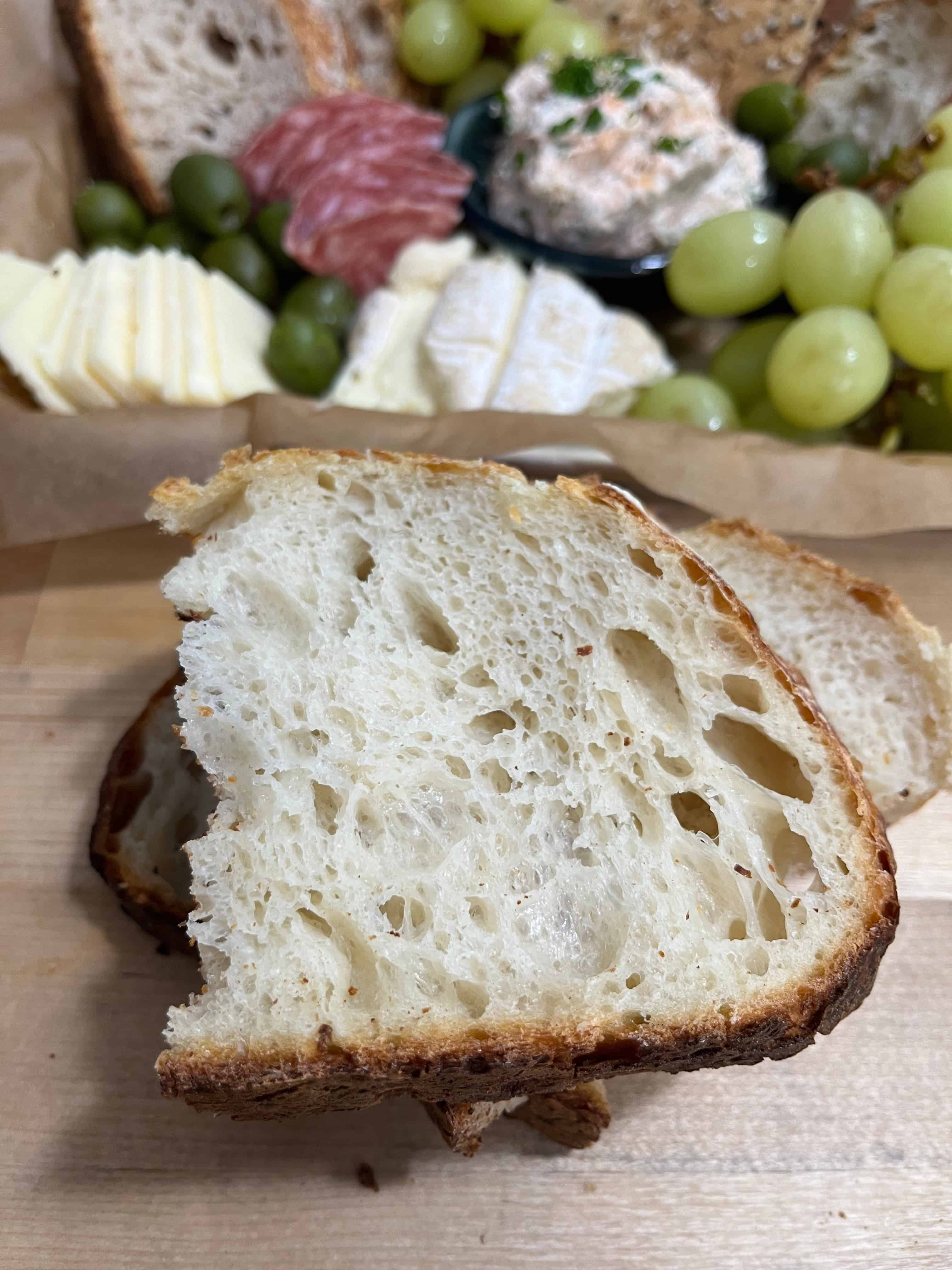 Sliced home-baked bread with cheese and charcuterie