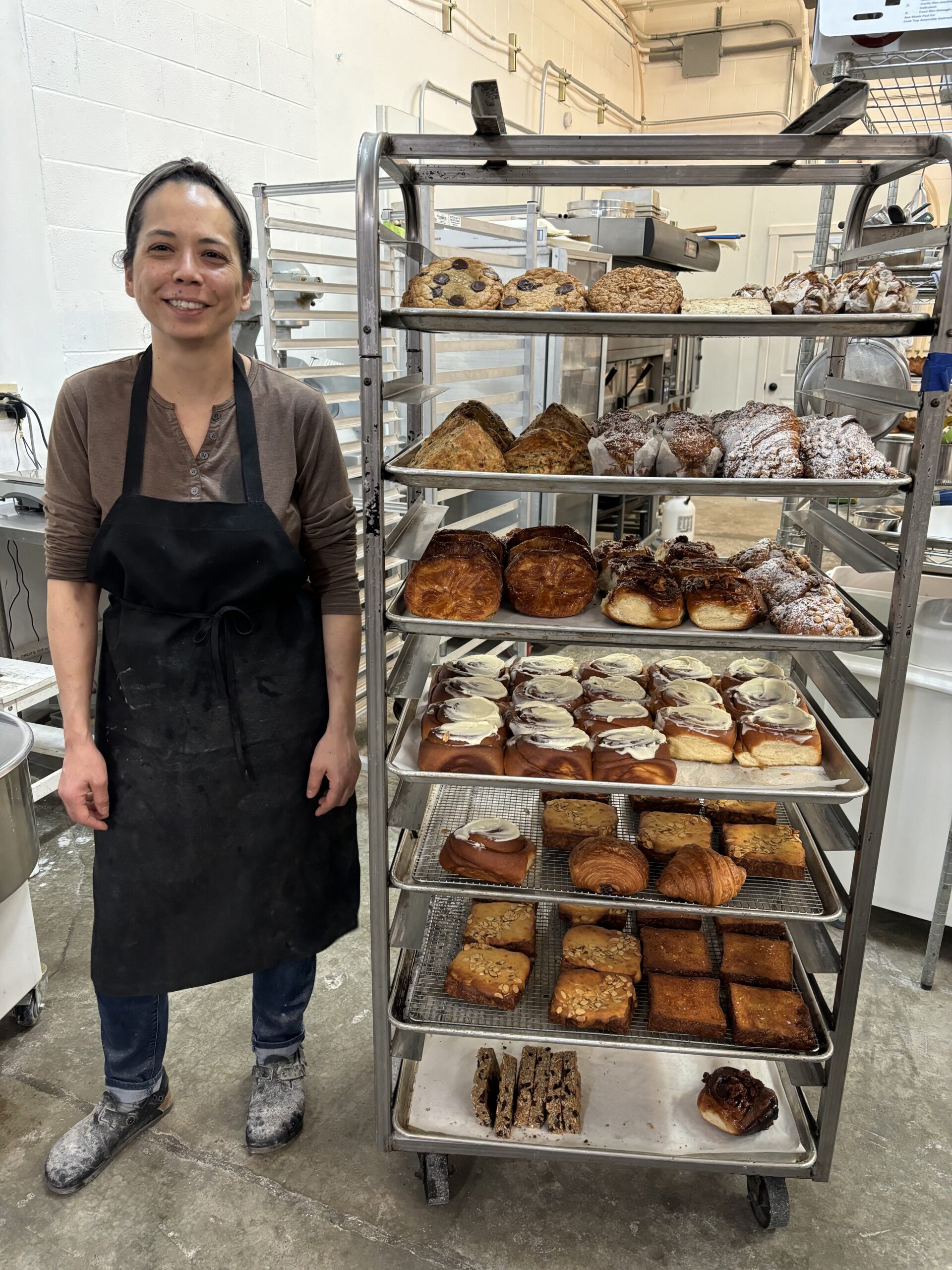 Baker next to her product.