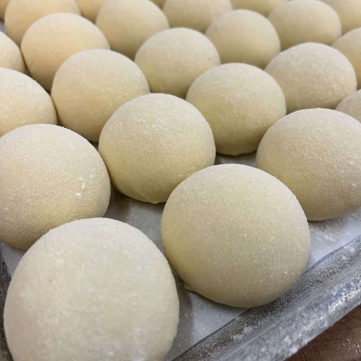 brioche dough balls on sheet tray