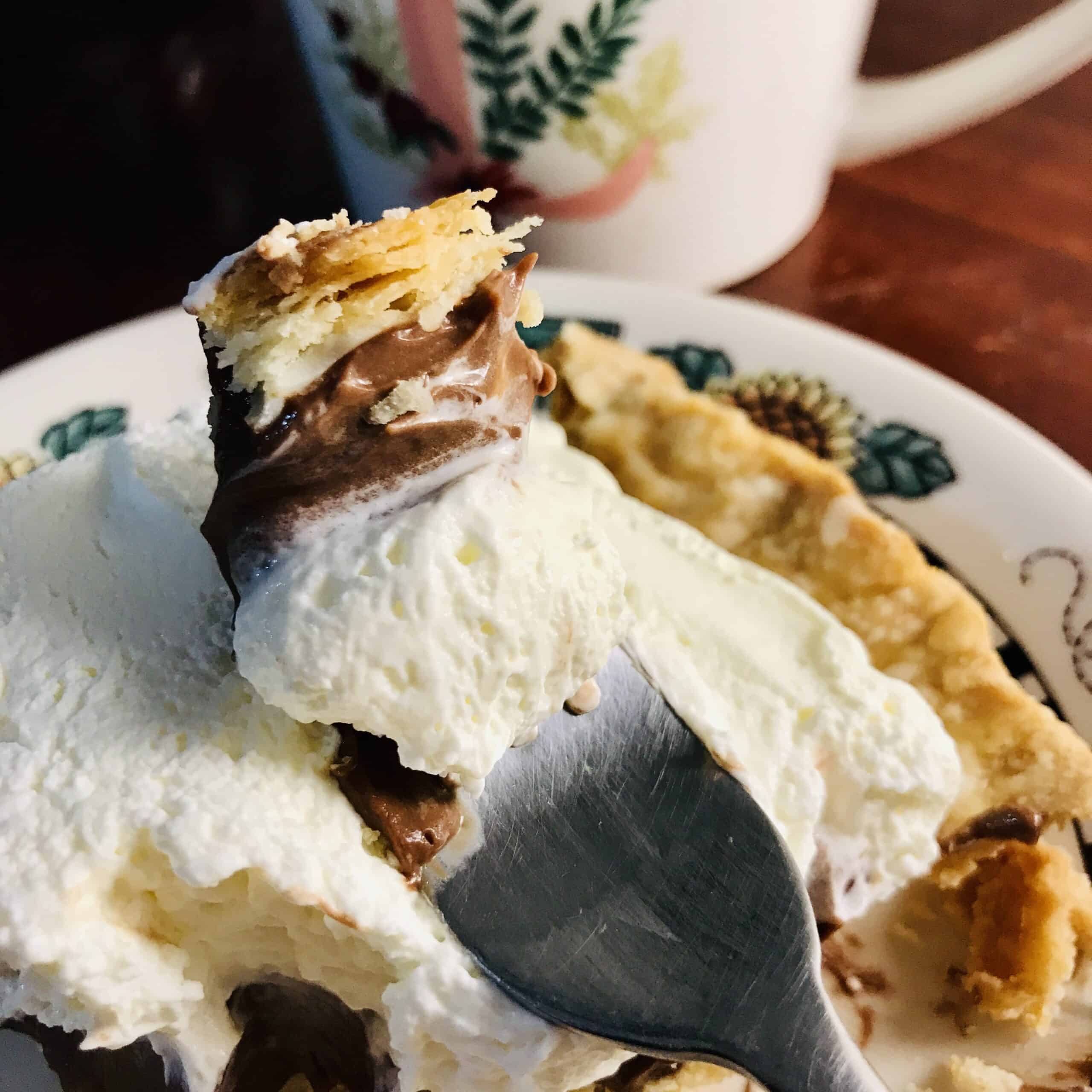 Chocolate cream pie with a flaky pie crust.