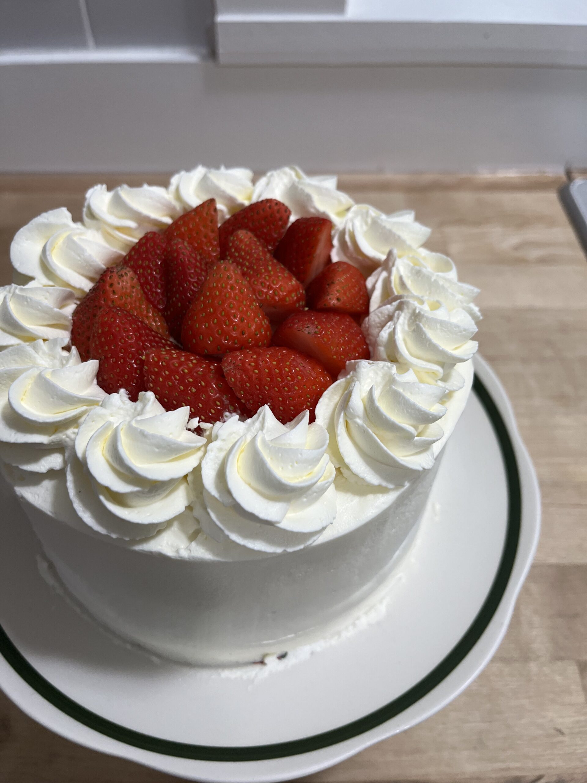 Whole cake with strawberries on counter