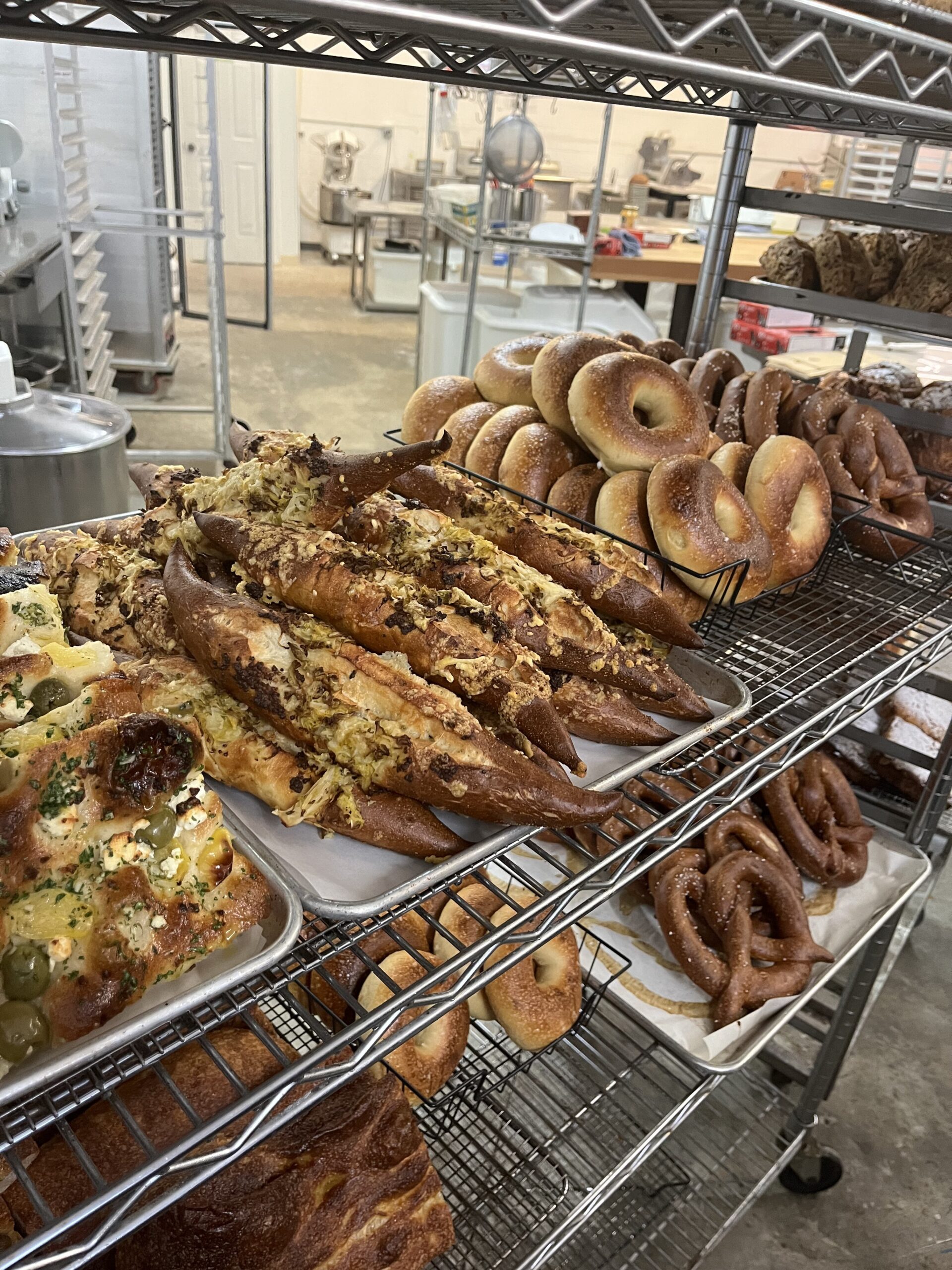 Bagels, pretzels and focaccia on a rack for sale.