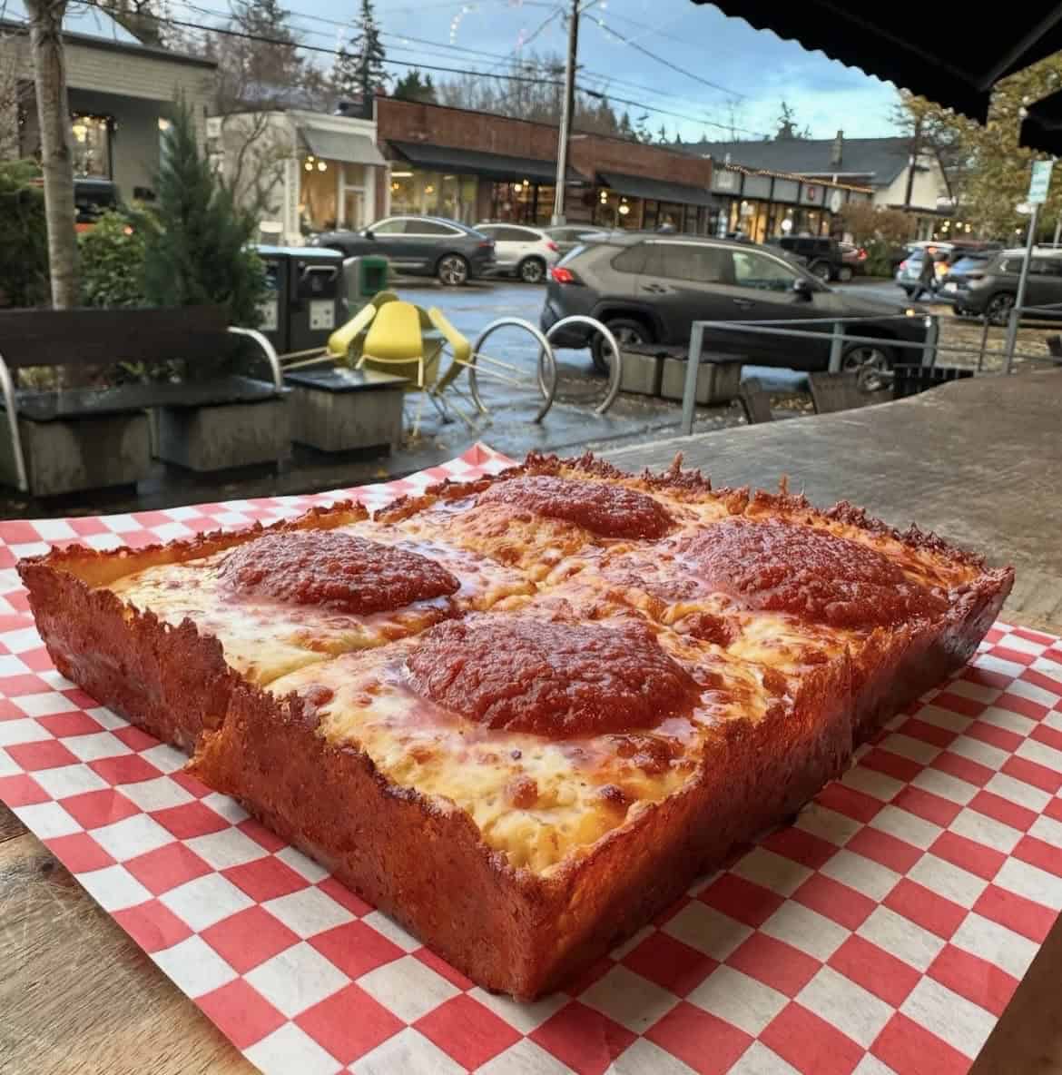 Finished Detroit-style pizza, tableside.