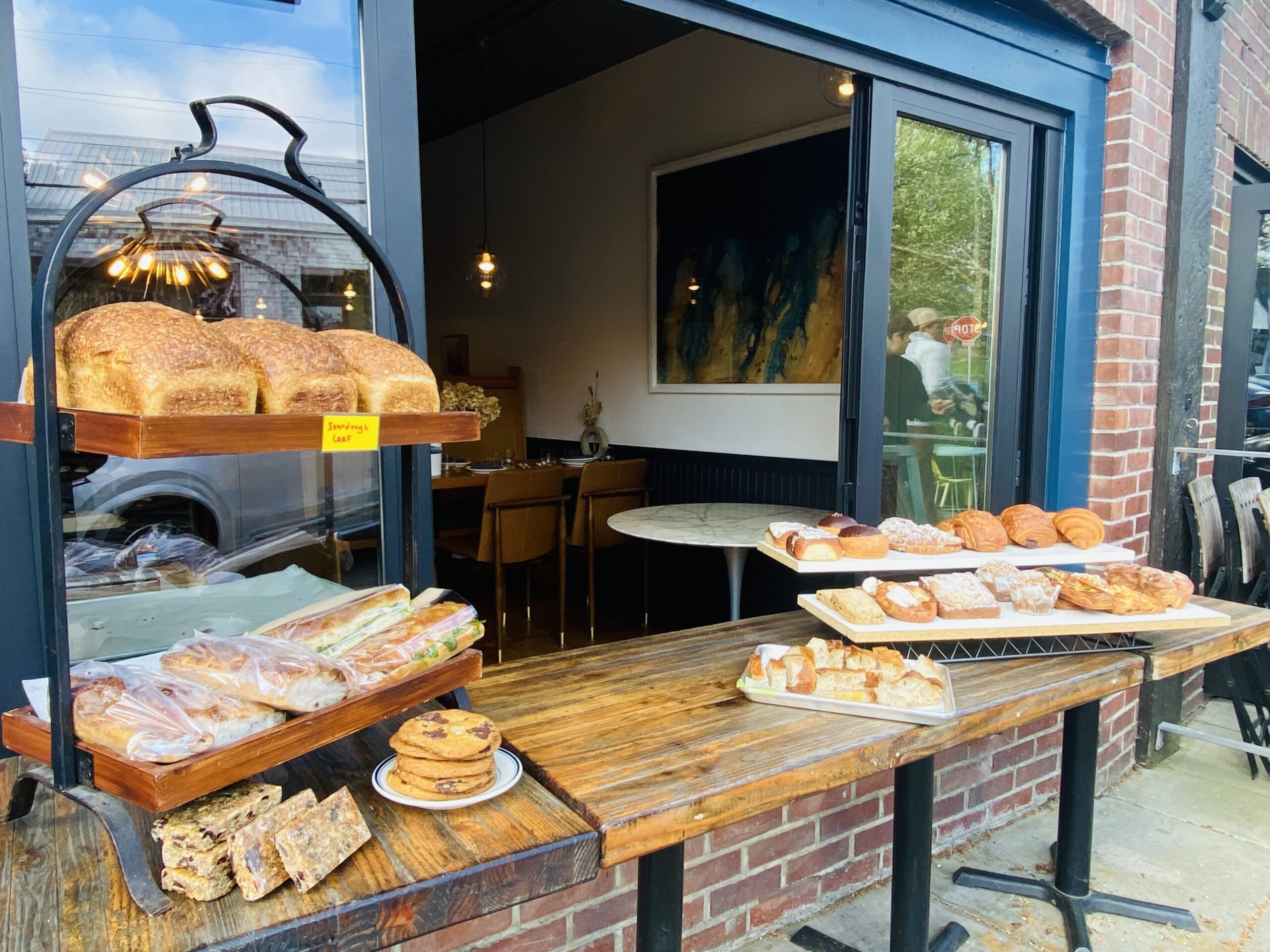 Bread and pastries on display in front of a restaurant.