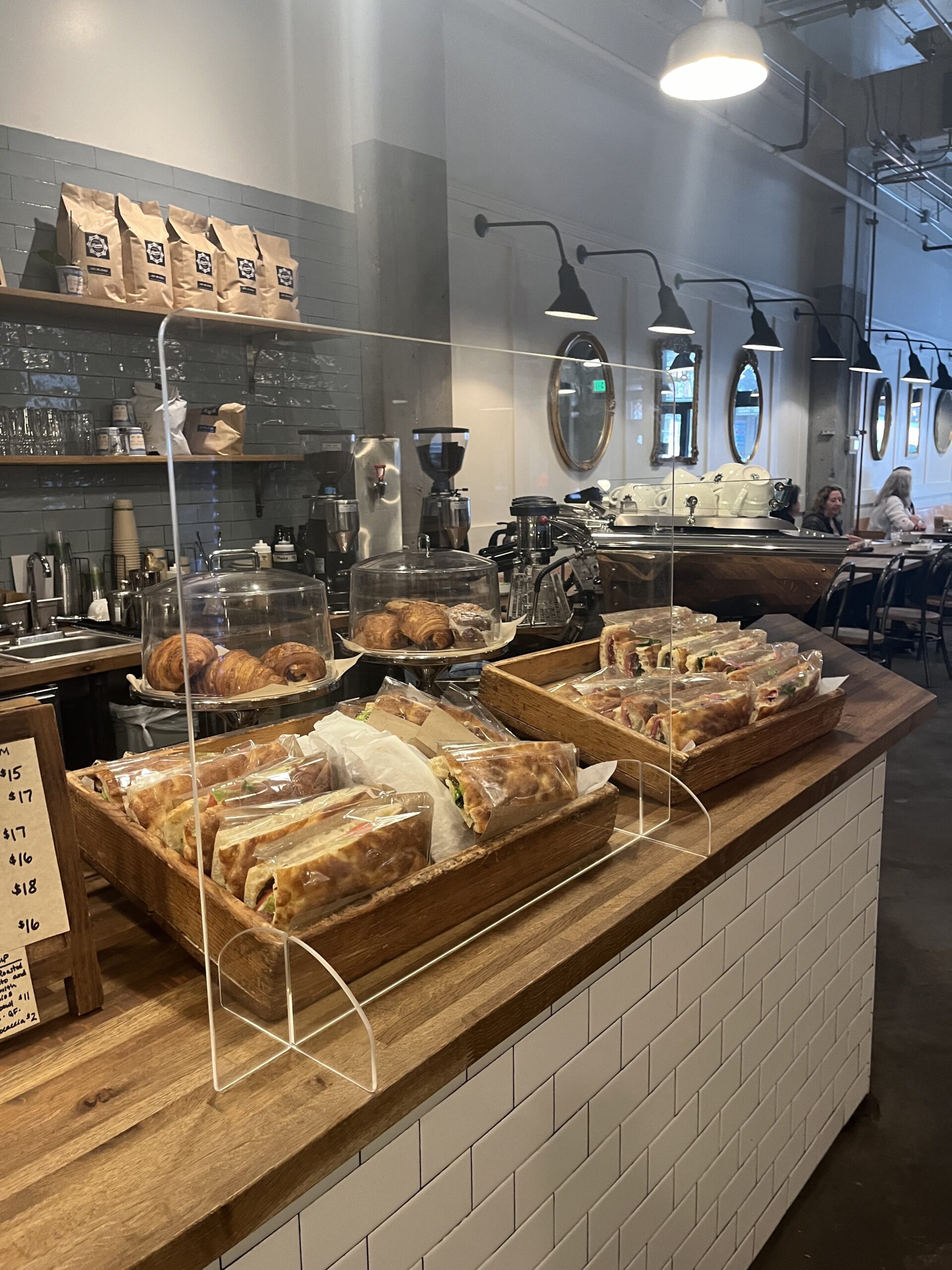 Sandwiches and pastries on the counter of a cafe.