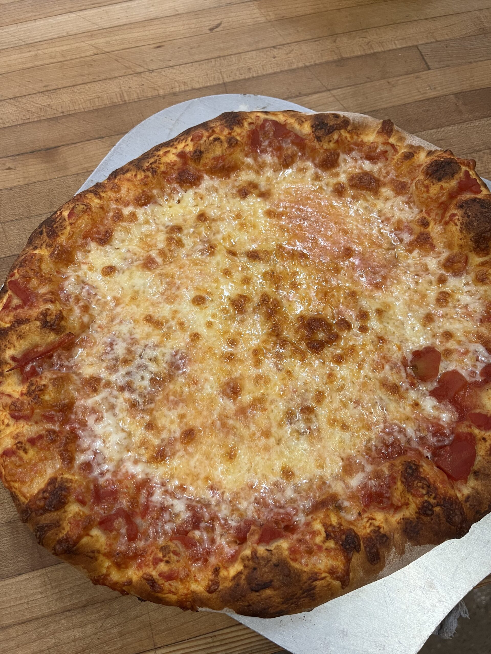 Cheese pizza on peel