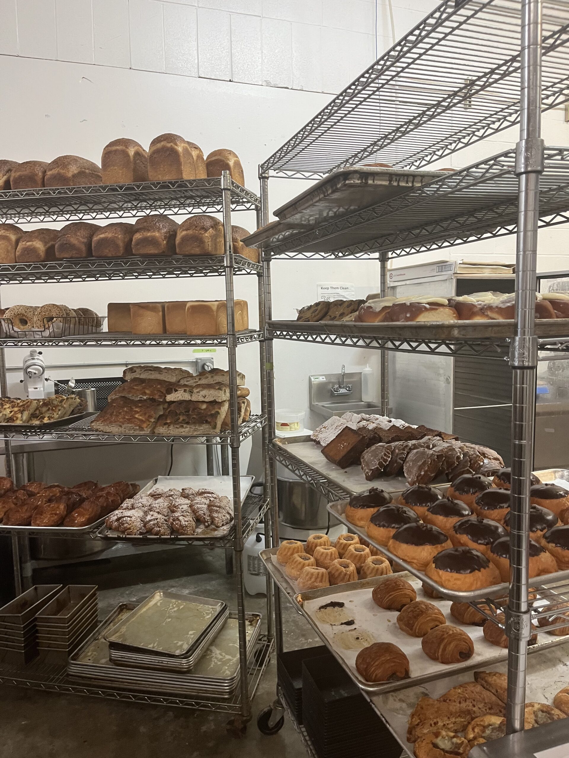Pastries and bread and on rack for sale.