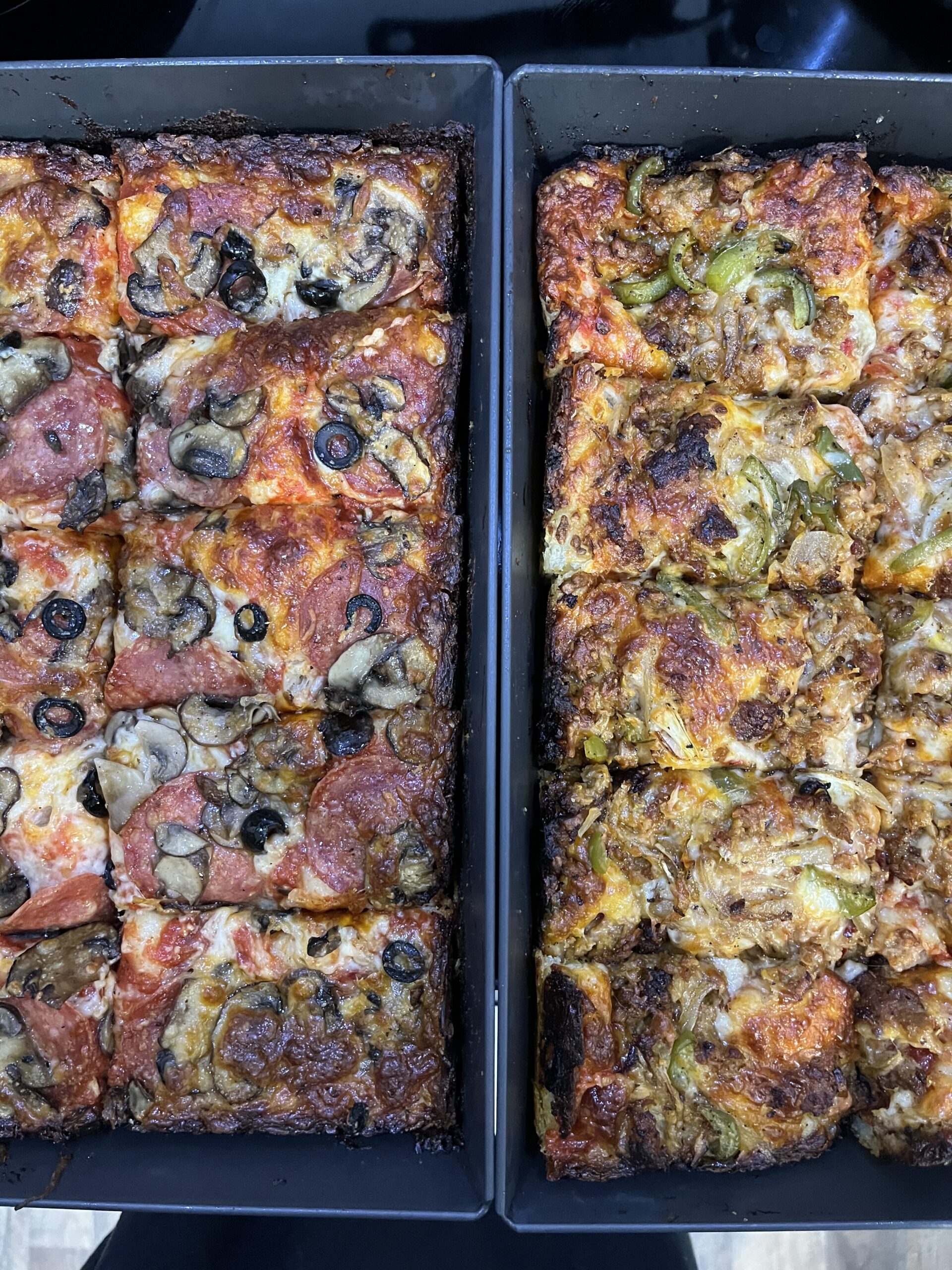 Two pan pizzas in Detroit pizza pans